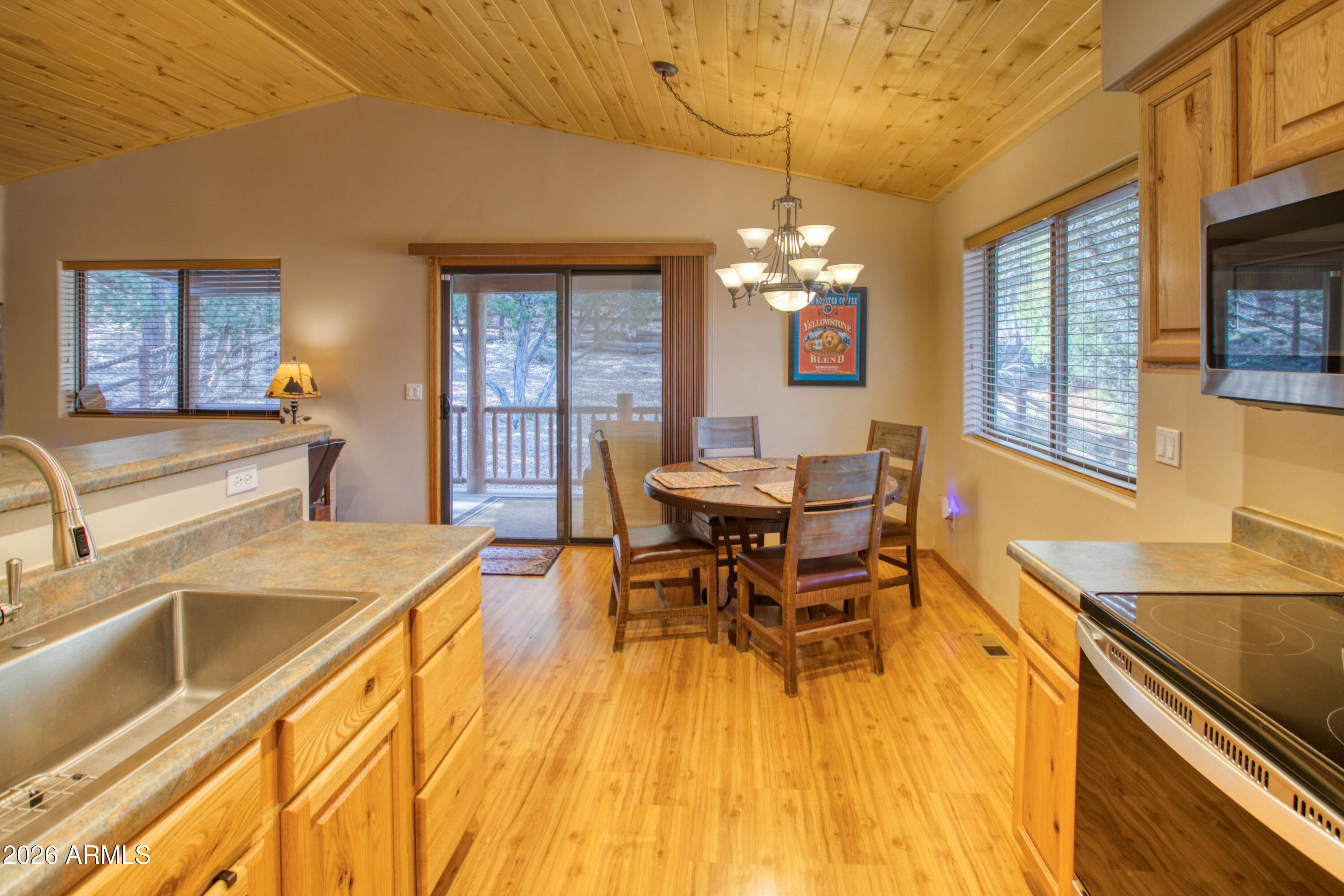 4840 West Cottage Loop Show Low, AZ 85901 - Photo 17 of 47 a view of a dining room with furniture a chandelier and a window