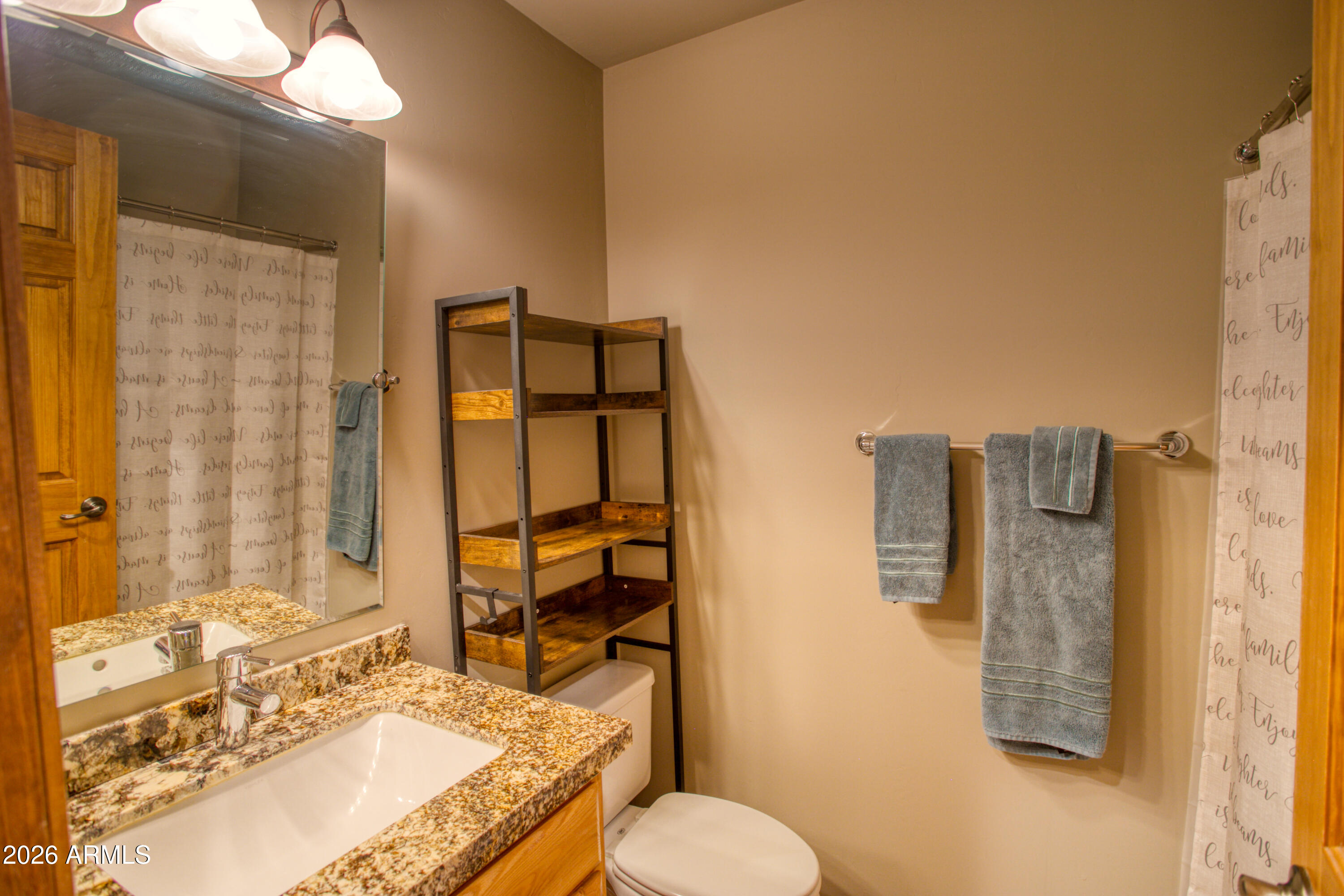 4840 West Cottage Loop Show Low, AZ 85901 - Photo 23 of 47 a bathroom with a granite countertop sink toilet and shower