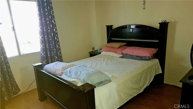 a bedroom with a bed and a potted plant