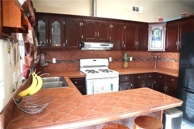 a kitchen with a sink appliances and cabinets