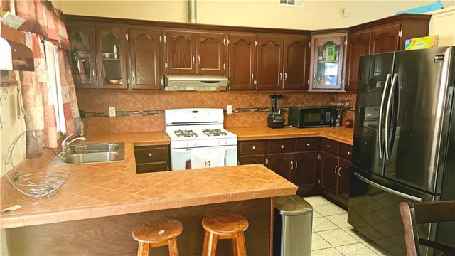a kitchen with a sink appliances and cabinets