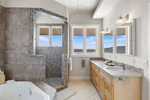 a bathroom with a tub a sink and mirror
