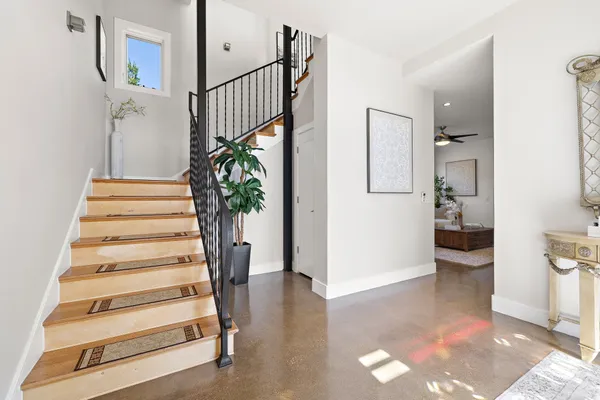 a utility room with stainless steel appliances granite countertop a stove a sink and a microwave