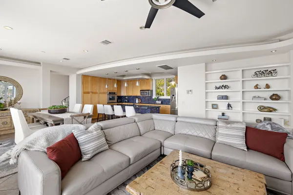 a living room with furniture fireplace and a large window