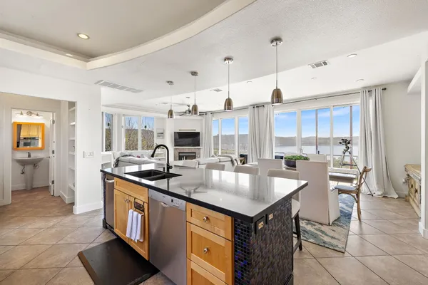 a kitchen with a table chairs refrigerator and cabinets