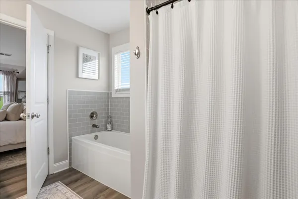 a bathroom with a bathtub and shower