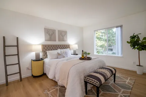 a bedroom with a bed and window