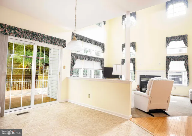 a living room with furniture a fireplace and a large window