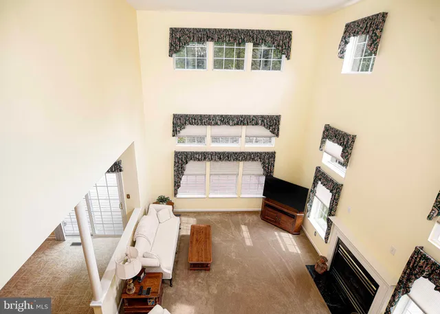 a kitchen with stainless steel appliances granite countertop a stove top oven a sink dishwasher a dining table and chairs with wooden floor