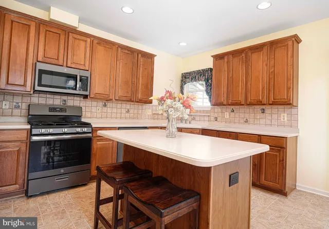 a kitchen with stainless steel appliances granite countertop a sink and cabinets