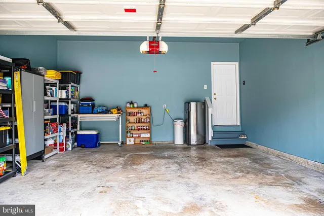 a view of a chair and table in backyard of the house