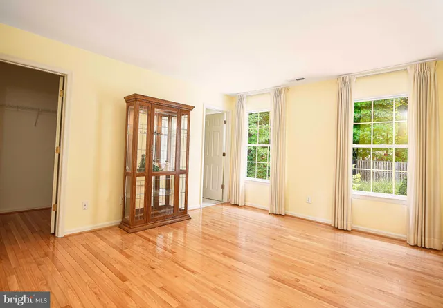 a view of a a dining room with furniture window and wooden floor
