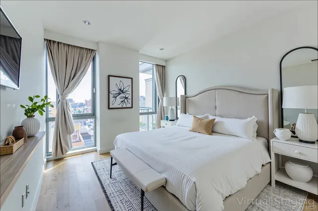 a bedroom with a large bed and a potted plant