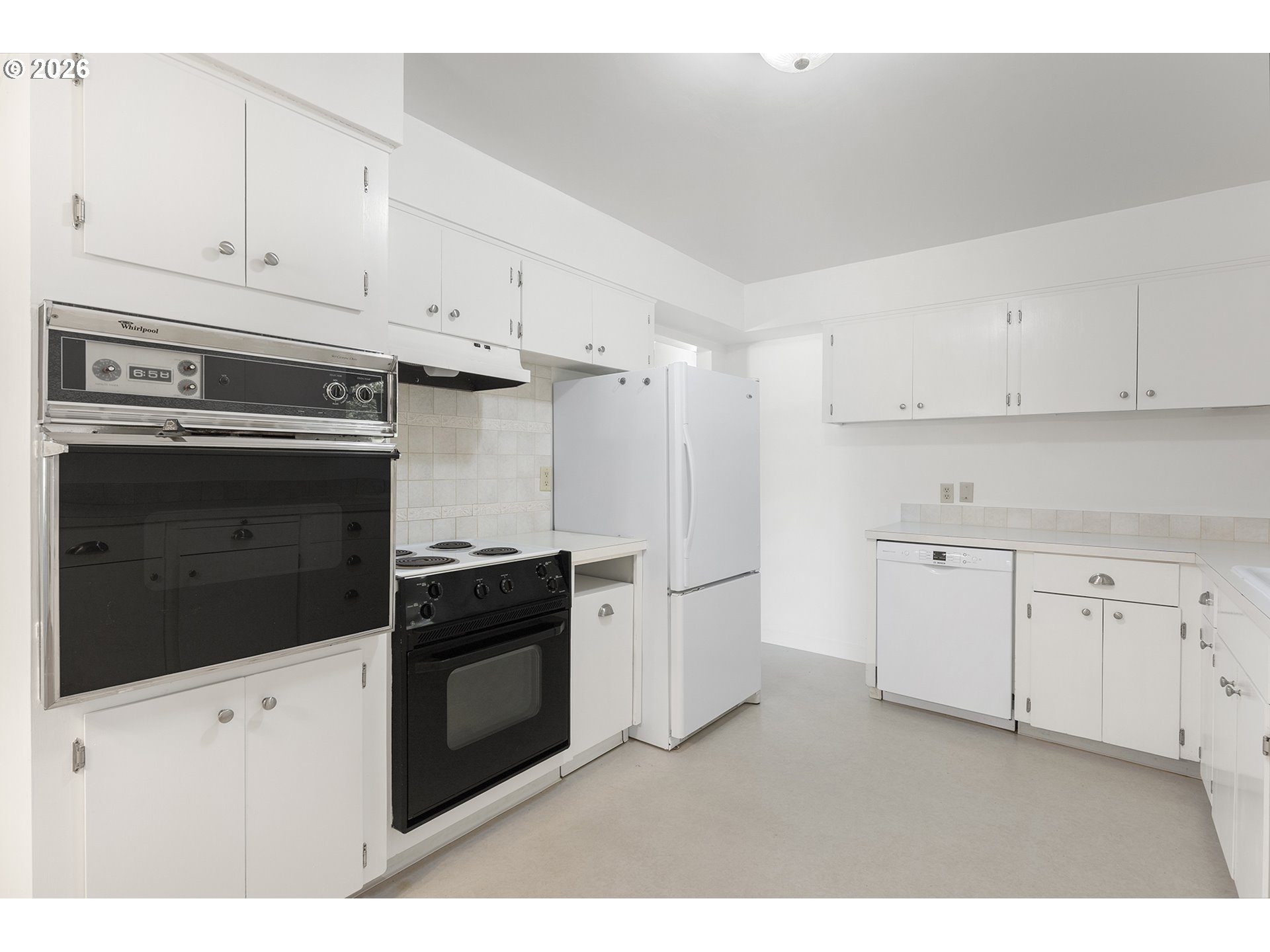 4355 Southwest 188th Avenue Beaverton, OR 97078 - Photo 15 of 42 a kitchen with white cabinets and stainless steel appliances