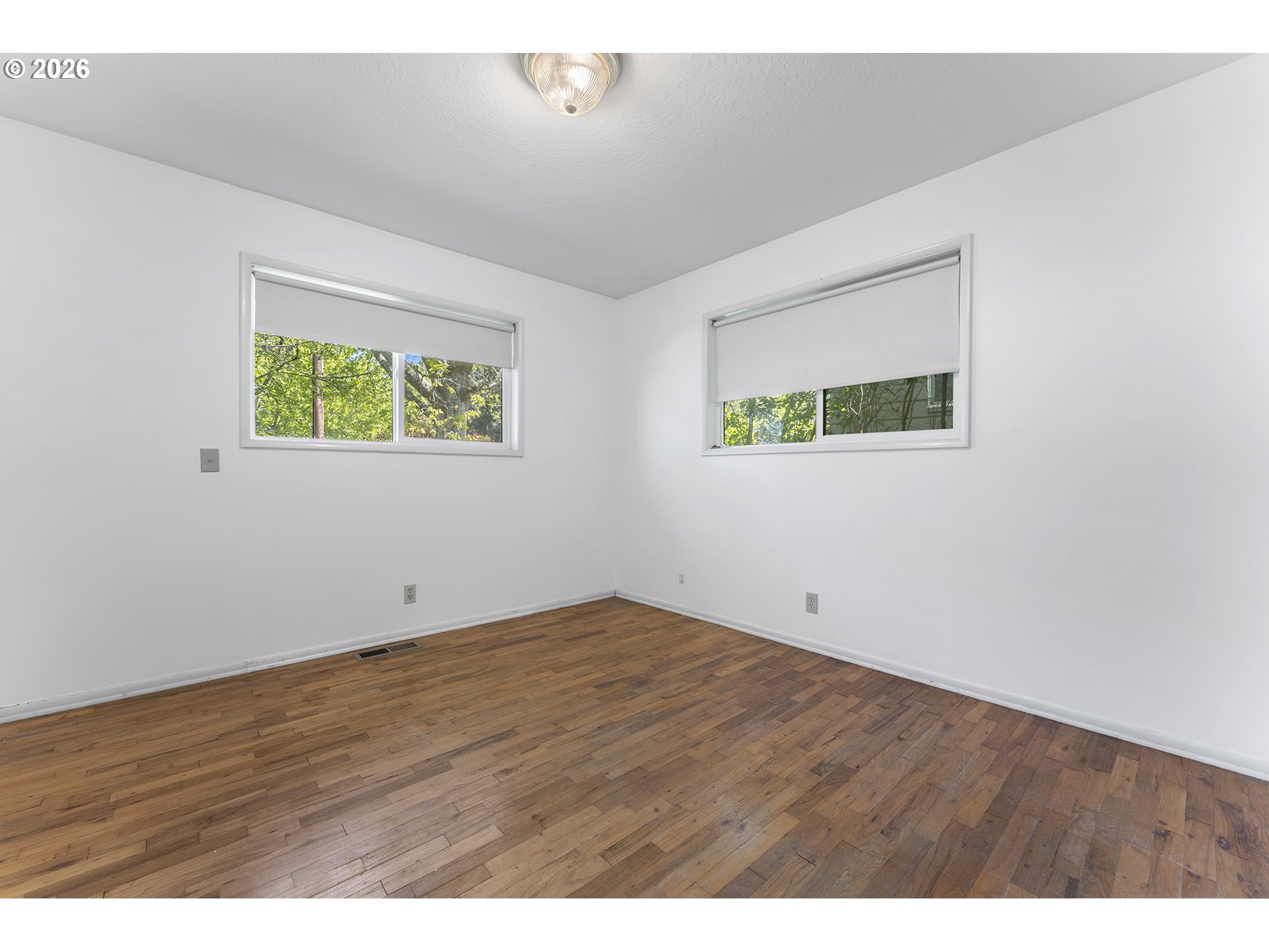 4355 Southwest 188th Avenue Beaverton, OR 97078 - Photo 22 of 42 an empty room with wooden floor and windows