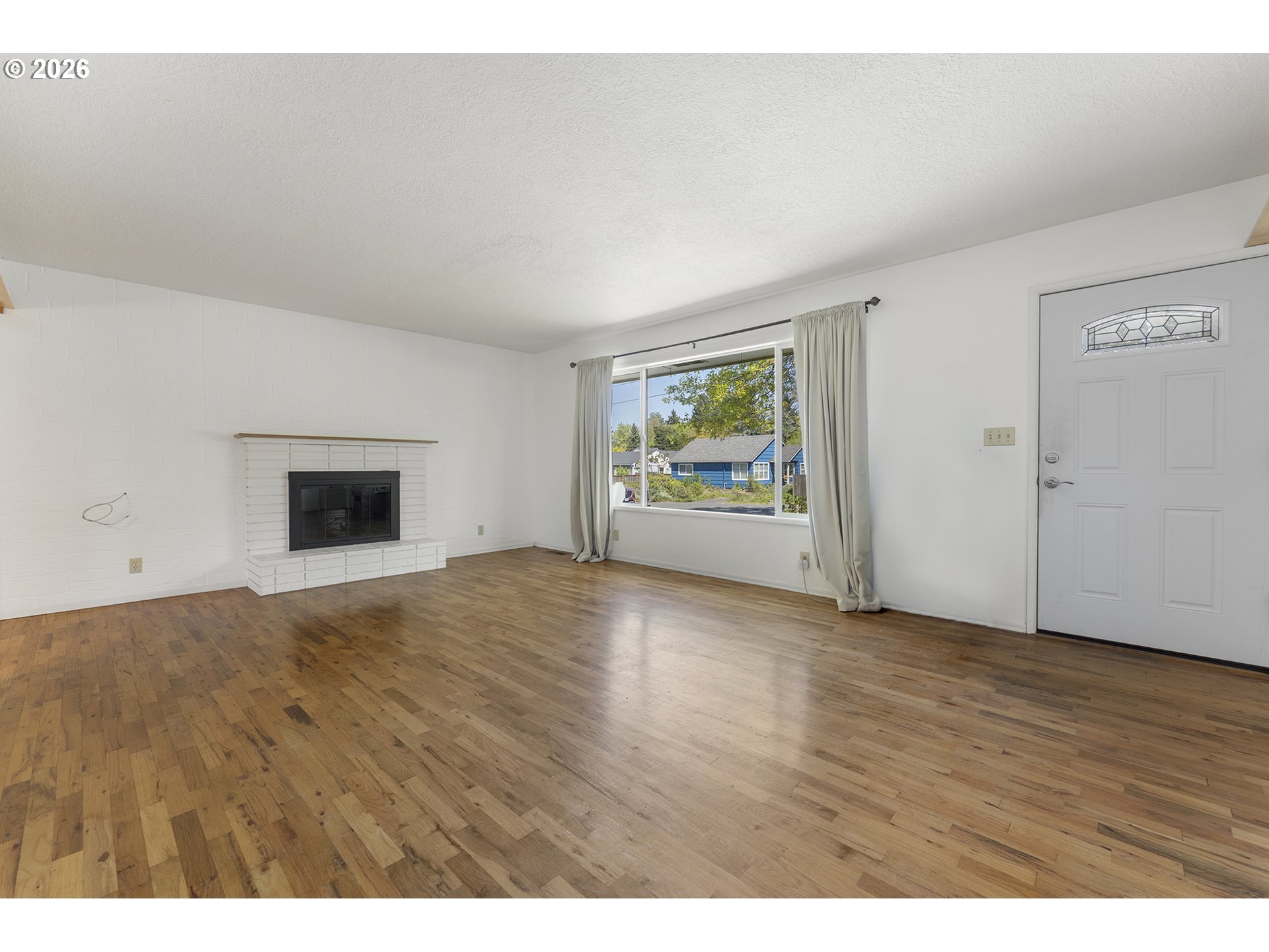 4355 Southwest 188th Avenue Beaverton, OR 97078 - Photo 6 of 42 a view of an empty room with window and wooden floor