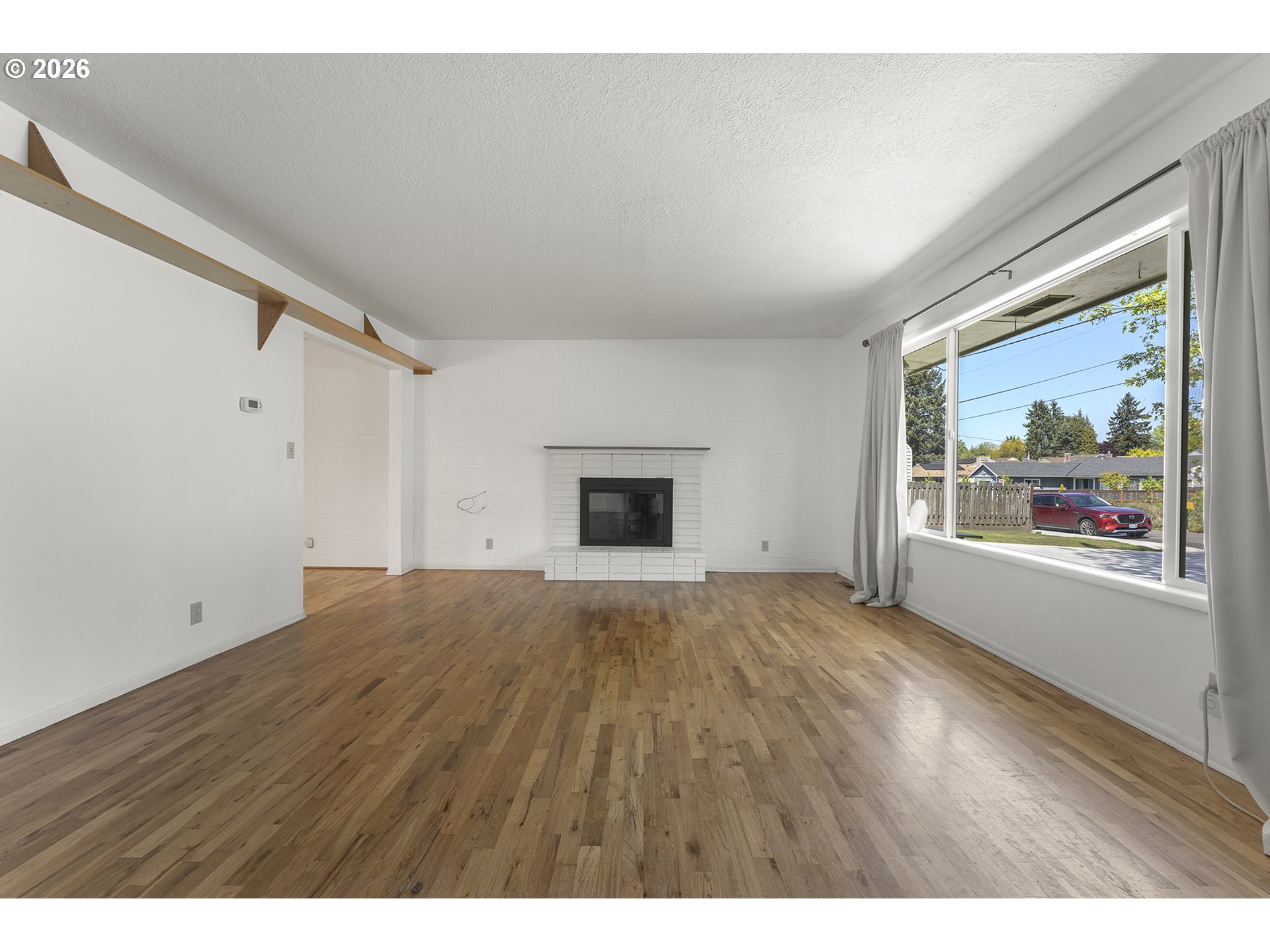 4355 Southwest 188th Avenue Beaverton, OR 97078 - Photo 7 of 42 a view of an empty room with a fireplace and a window