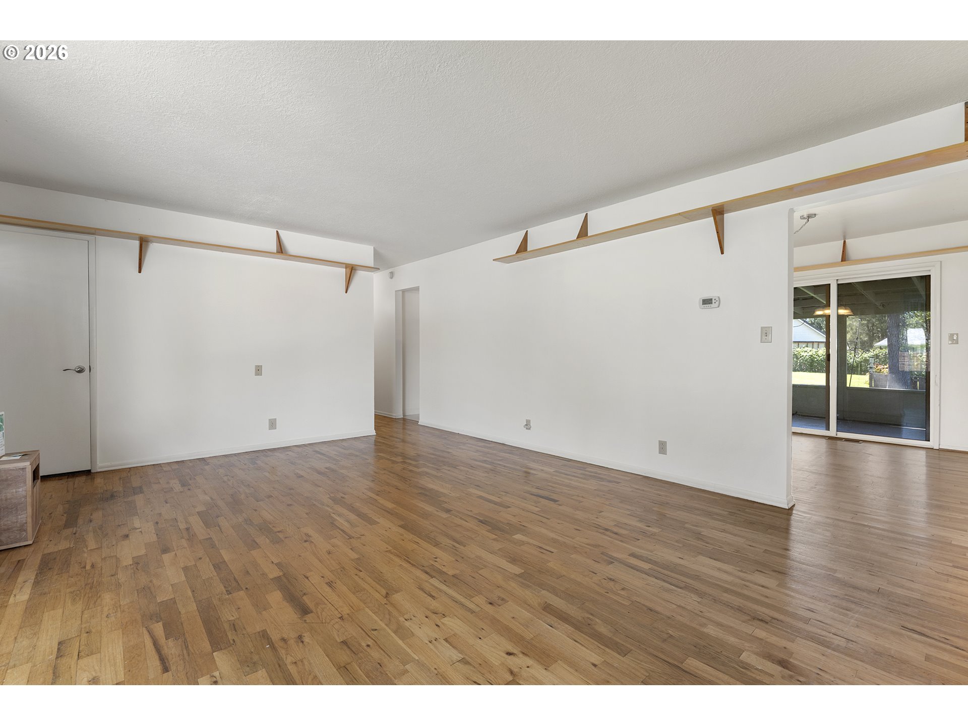 4355 Southwest 188th Avenue Beaverton, OR 97078 - Photo 9 of 42 a view of an empty room with wooden floor