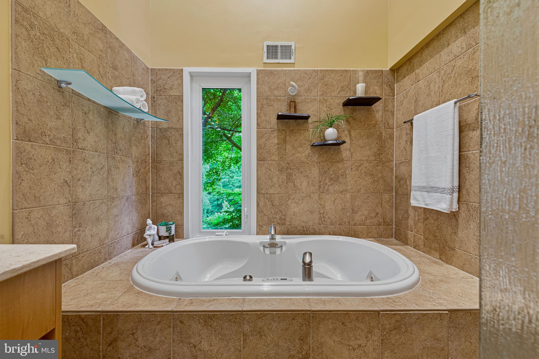 5196 27th Street Northwest Washington, DC 20008 - Photo 42 of 68 a bath tub sitting in a bathroom next to a shower