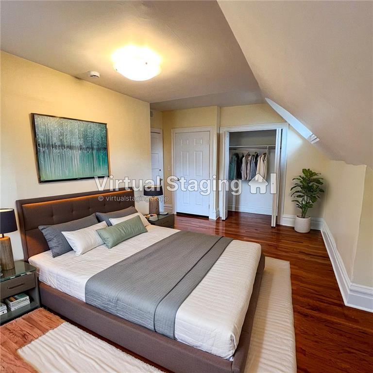 926 Savannah Avenue, Unit 3 Pittsburgh, PA 15221 - Photo 11 of 13 a bedroom with a bed and a painting on the wall