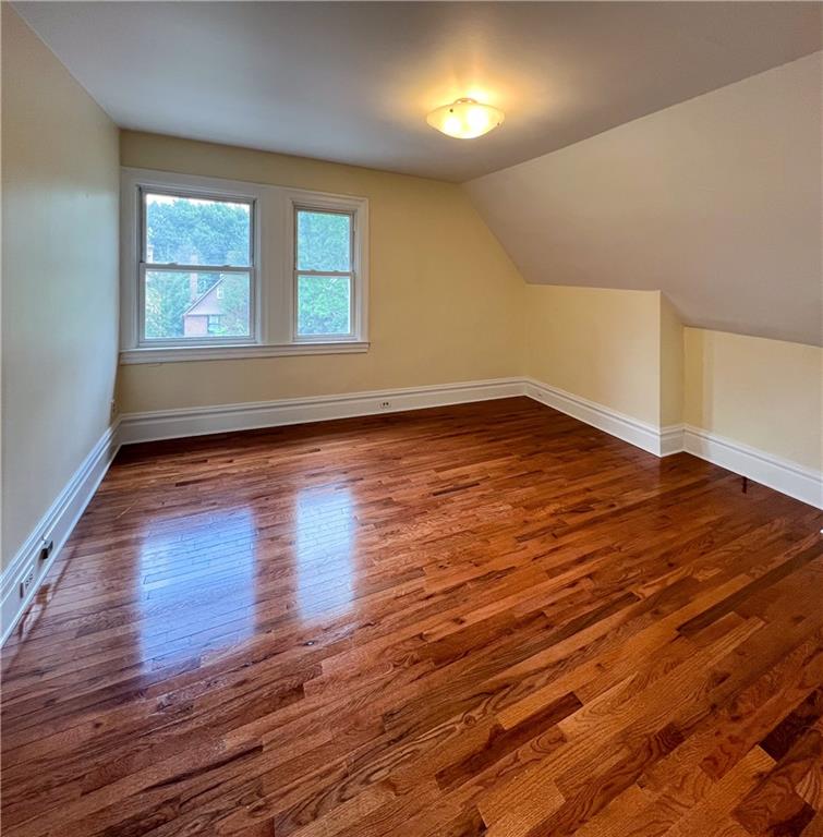 926 Savannah Avenue, Unit 3 Pittsburgh, PA 15221 - Photo 8 of 13 wooden floor in an empty room with a window