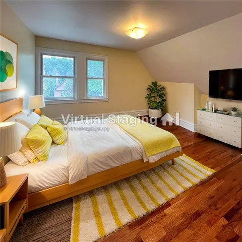 a bedroom with a bed and flat screen tv