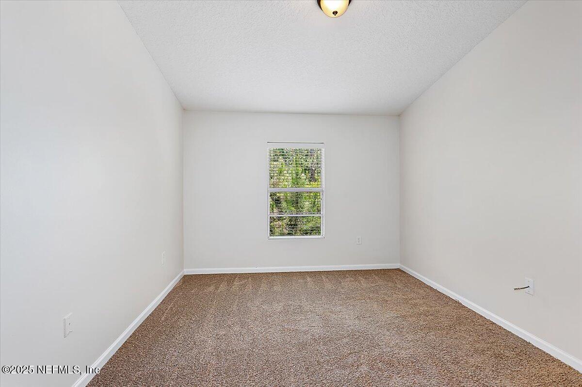 7920 Merrill Road, Unit 1014 Jacksonville, FL 32277 - Photo 8 of 12 08-Primary Bedroom