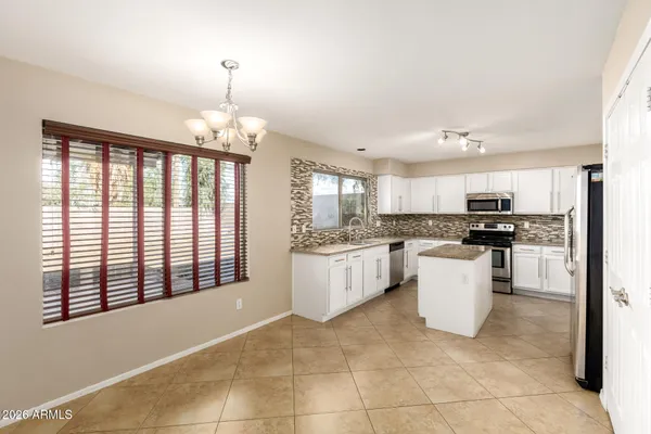 a large white kitchen with a large window