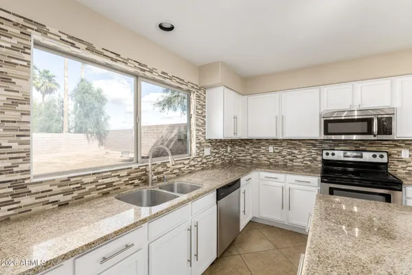 a kitchen with a sink stove and microwave
