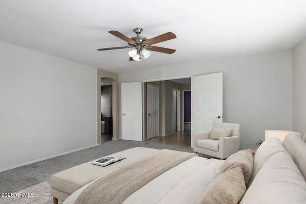 a bedroom with a bed and a chandelier