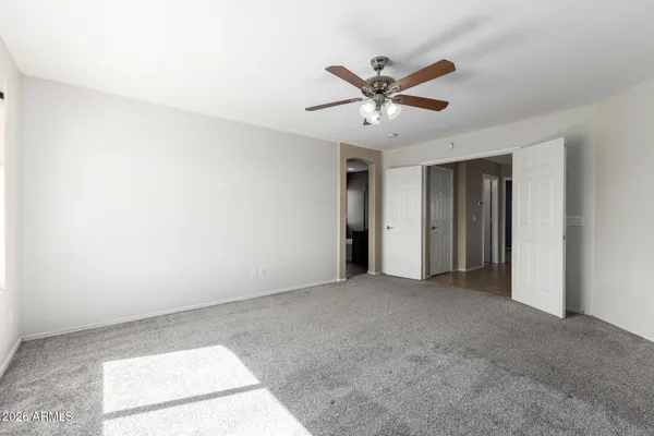 a view of a livingroom with a ceiling fan and window