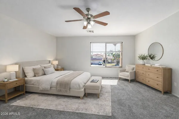 an empty room with windows and ceiling fan