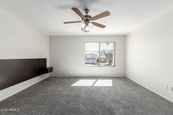 a spacious bathroom with a granite countertop sink and a mirror