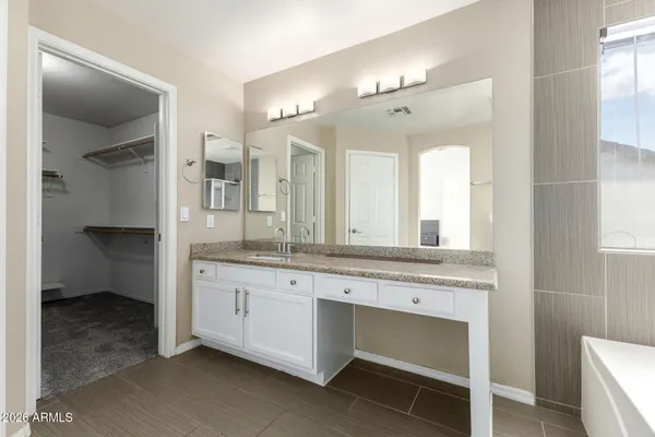 a bathroom with a tub shower and sink