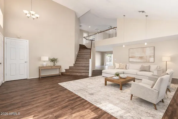 a living room with furniture and wooden floor