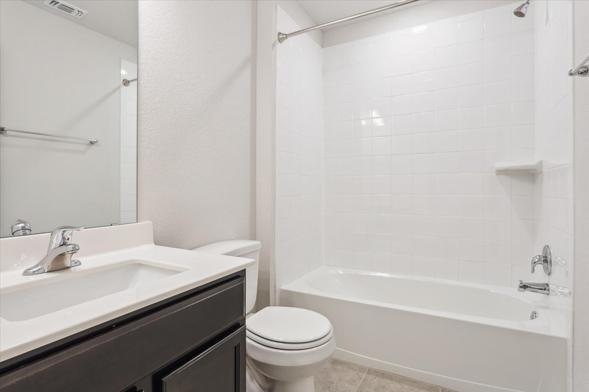 5830 Copano Road Belton, TX 76513 - Photo 28 of 34 Bathroom with visible vents, toilet, tub / shower combination, vanity, and tile patterned floors