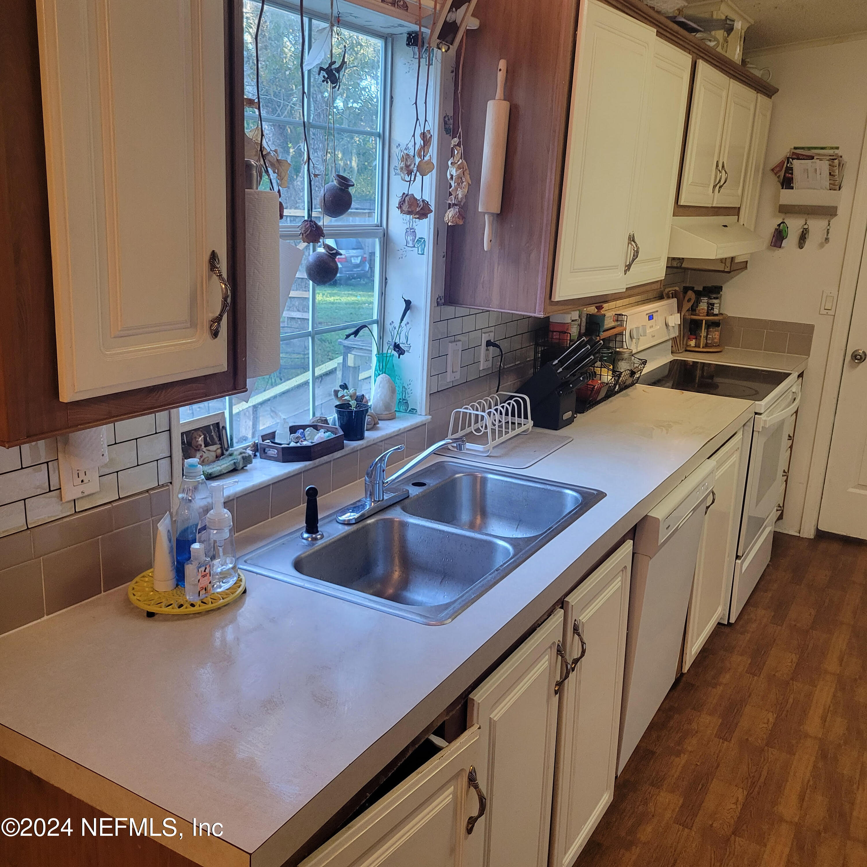 7616 Townsend Road Jacksonville, FL 32244 - Photo 11 of 38 a kitchen with sink a stove and a microwave oven