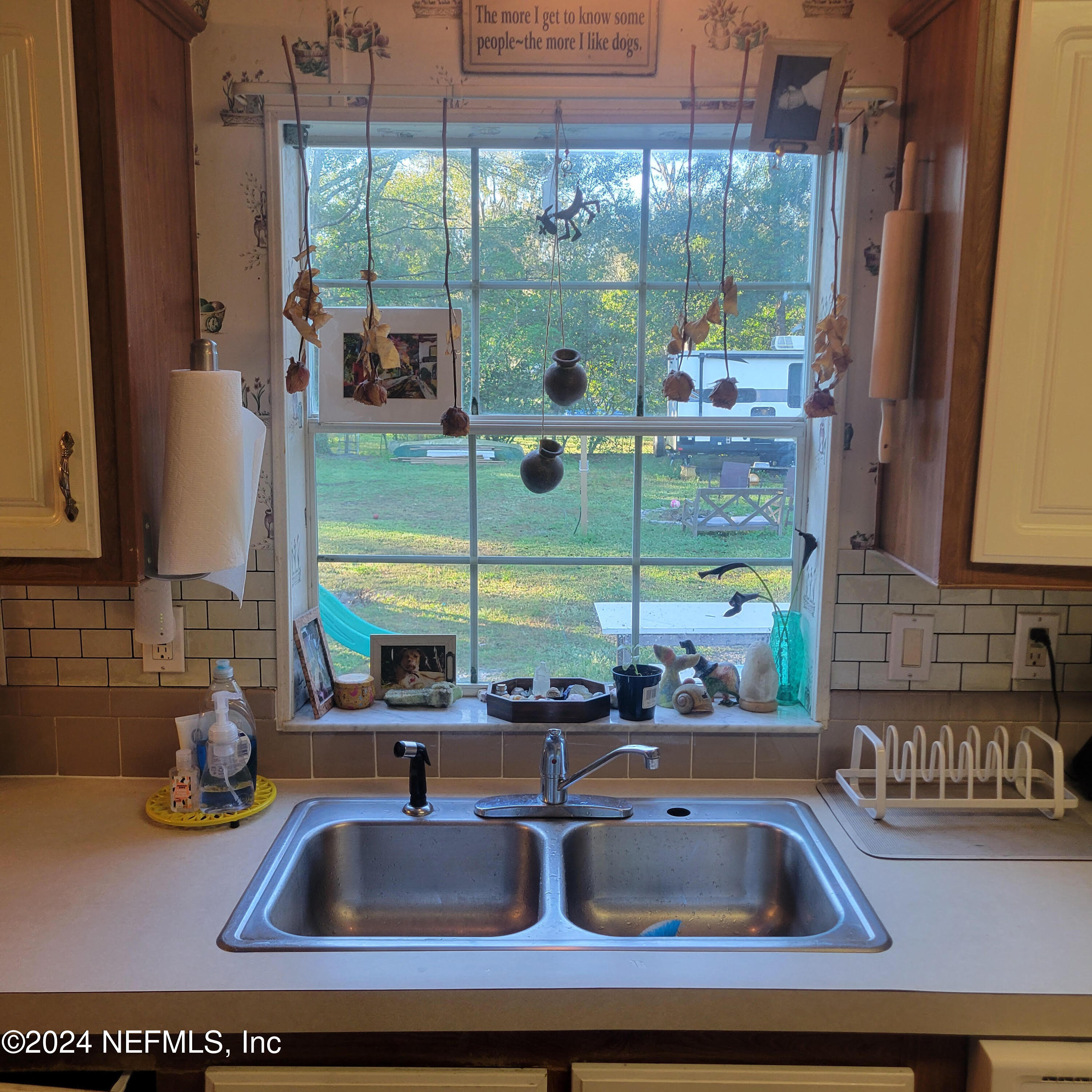 7616 Townsend Road Jacksonville, FL 32244 - Photo 12 of 38 a kitchen sink with a view of living room and a window