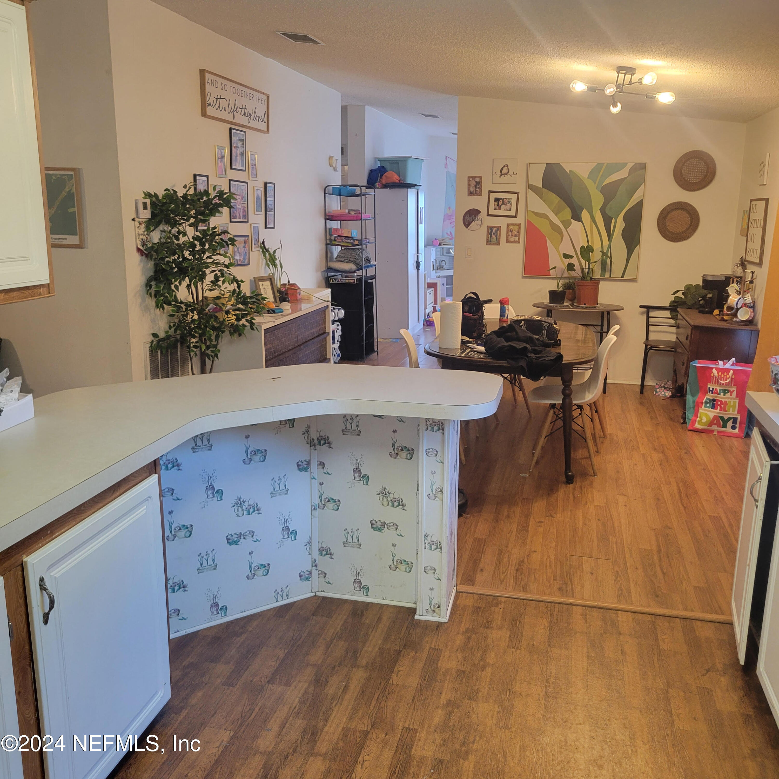 7616 Townsend Road Jacksonville, FL 32244 - Photo 14 of 38 a view of a kitchen with furniture and wooden floor