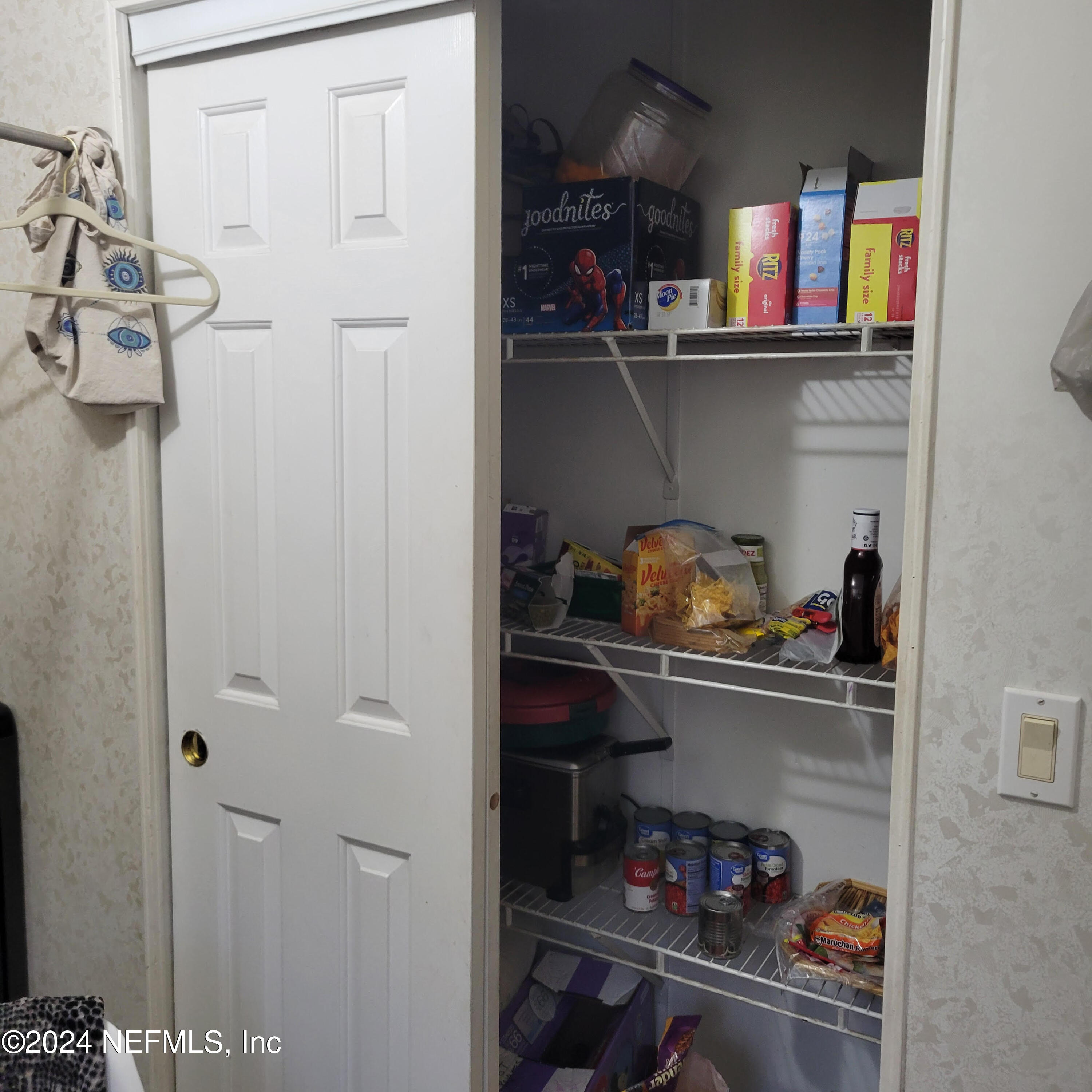 7616 Townsend Road Jacksonville, FL 32244 - Photo 17 of 38 a kitchen with a refrigerator and cabinets