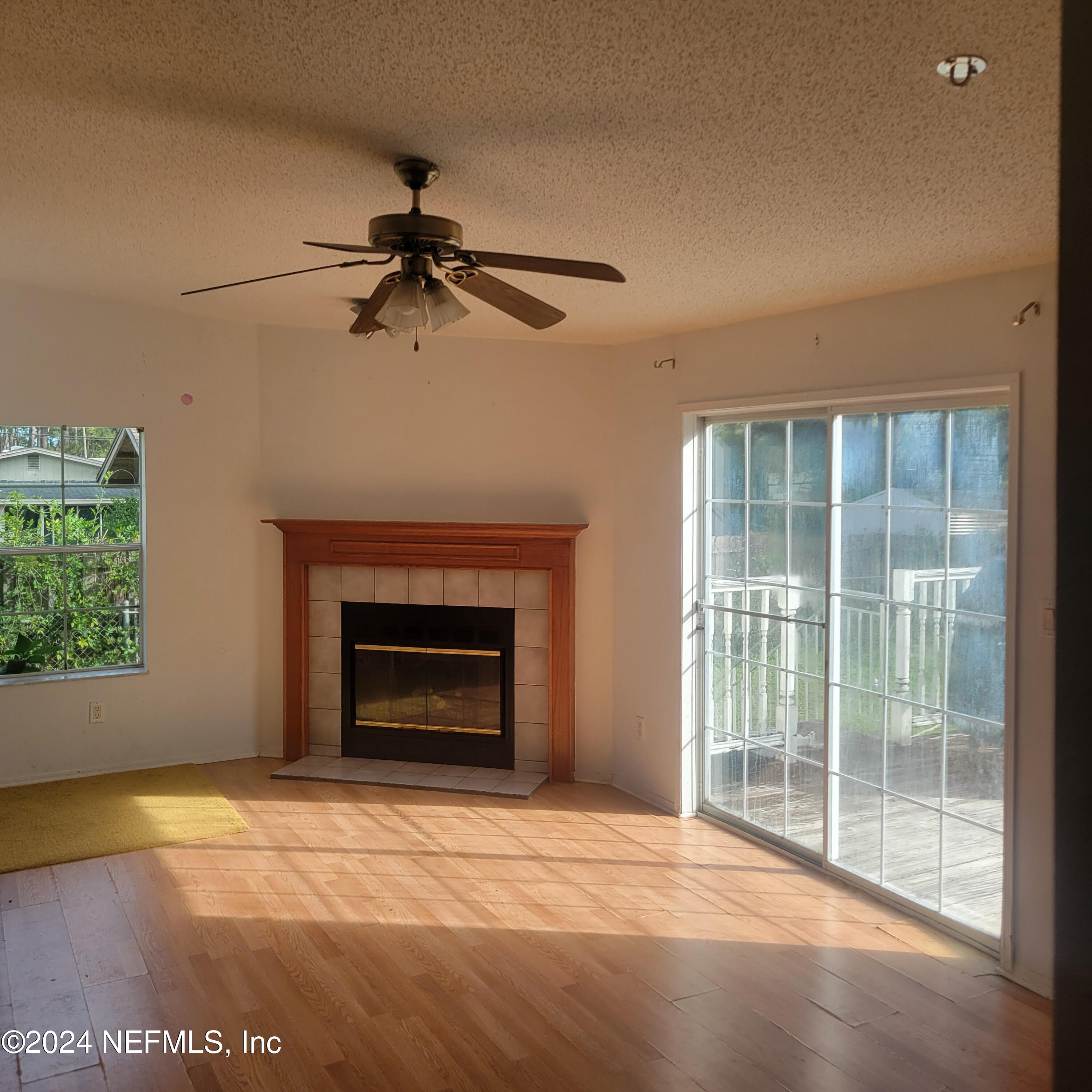 7616 Townsend Road Jacksonville, FL 32244 - Photo 19 of 38 a view of an empty room with a fireplace and a window