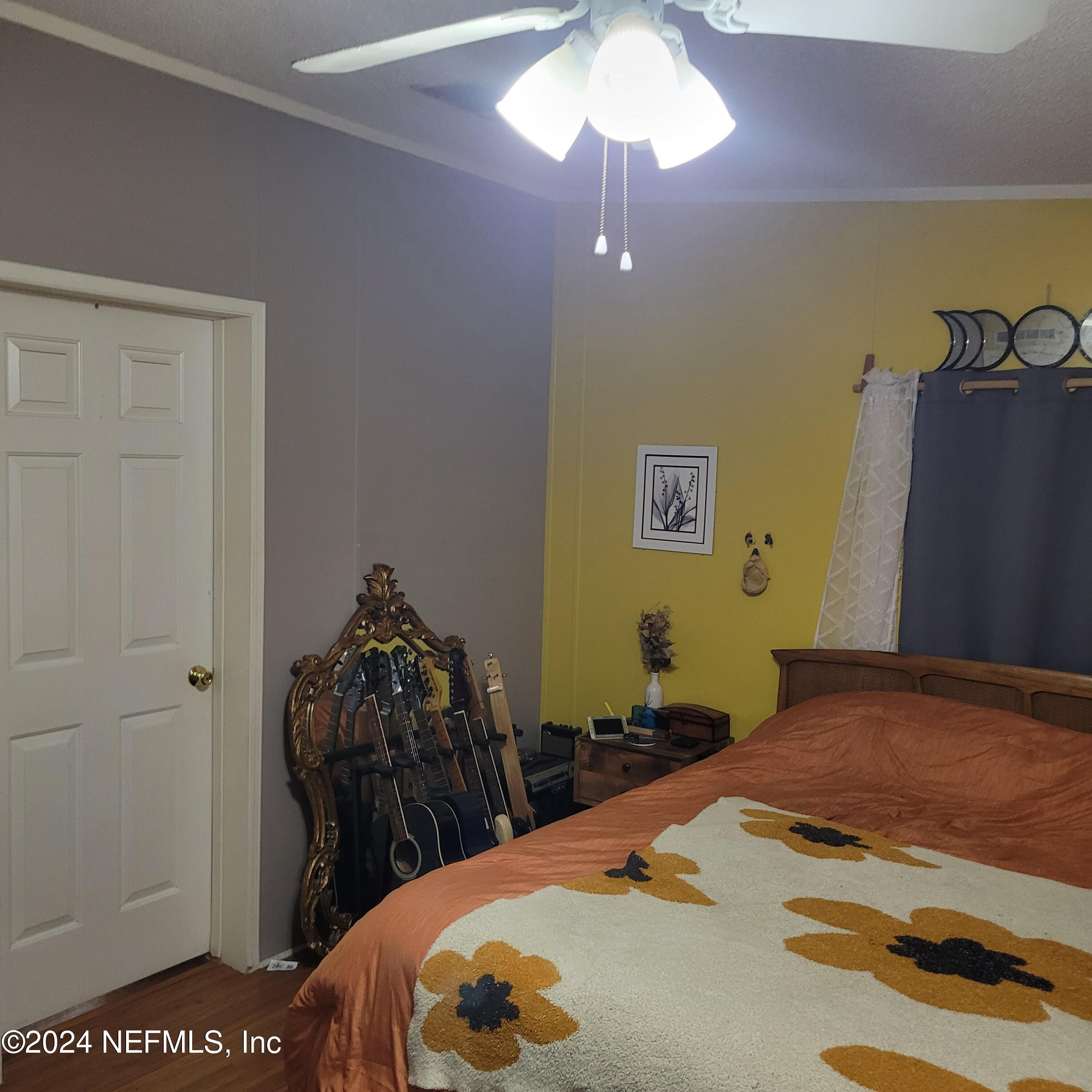 7616 Townsend Road Jacksonville, FL 32244 - Photo 26 of 38 a bedroom with a bed and a chandelier
