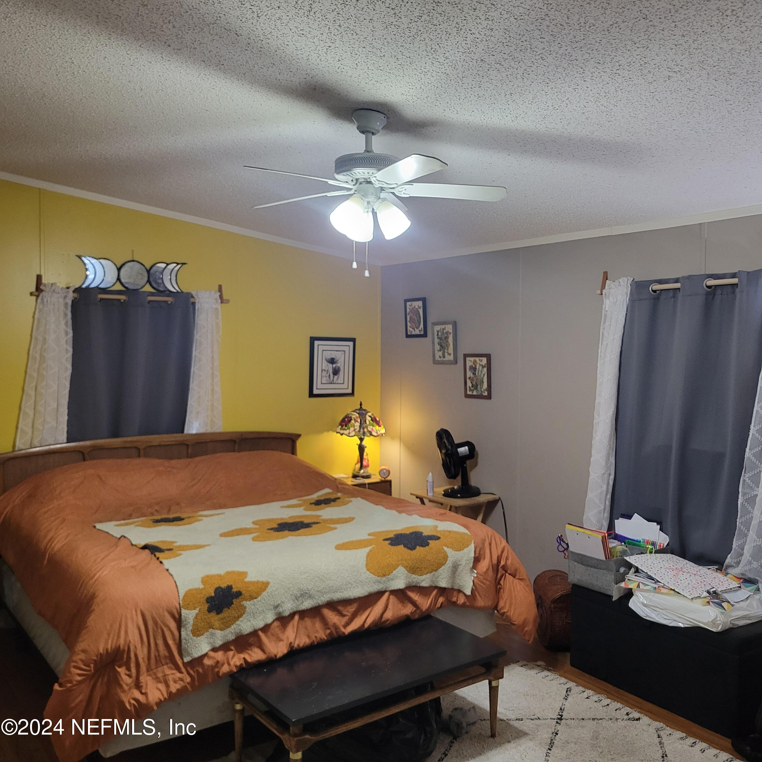7616 Townsend Road Jacksonville, FL 32244 - Photo 28 of 38 a bedroom with a bed and a chandelier
