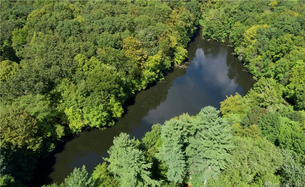 an aerial view of a house with a yard and lake view
