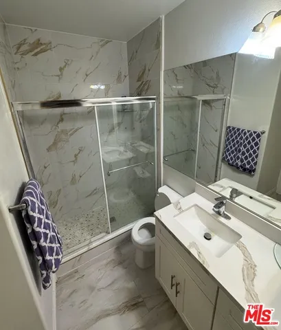 a bathroom with a sink toilet and shower