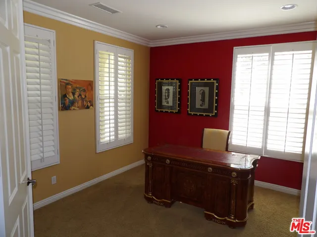 a room with projector and windows