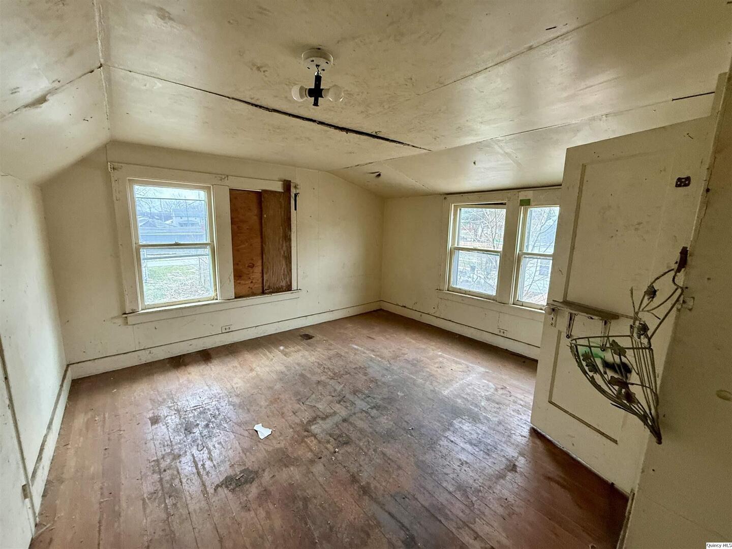 822 North 12th Street Quincy, IL 62301 - Photo 6 of 12 a view of an empty room with a window and wooden floor