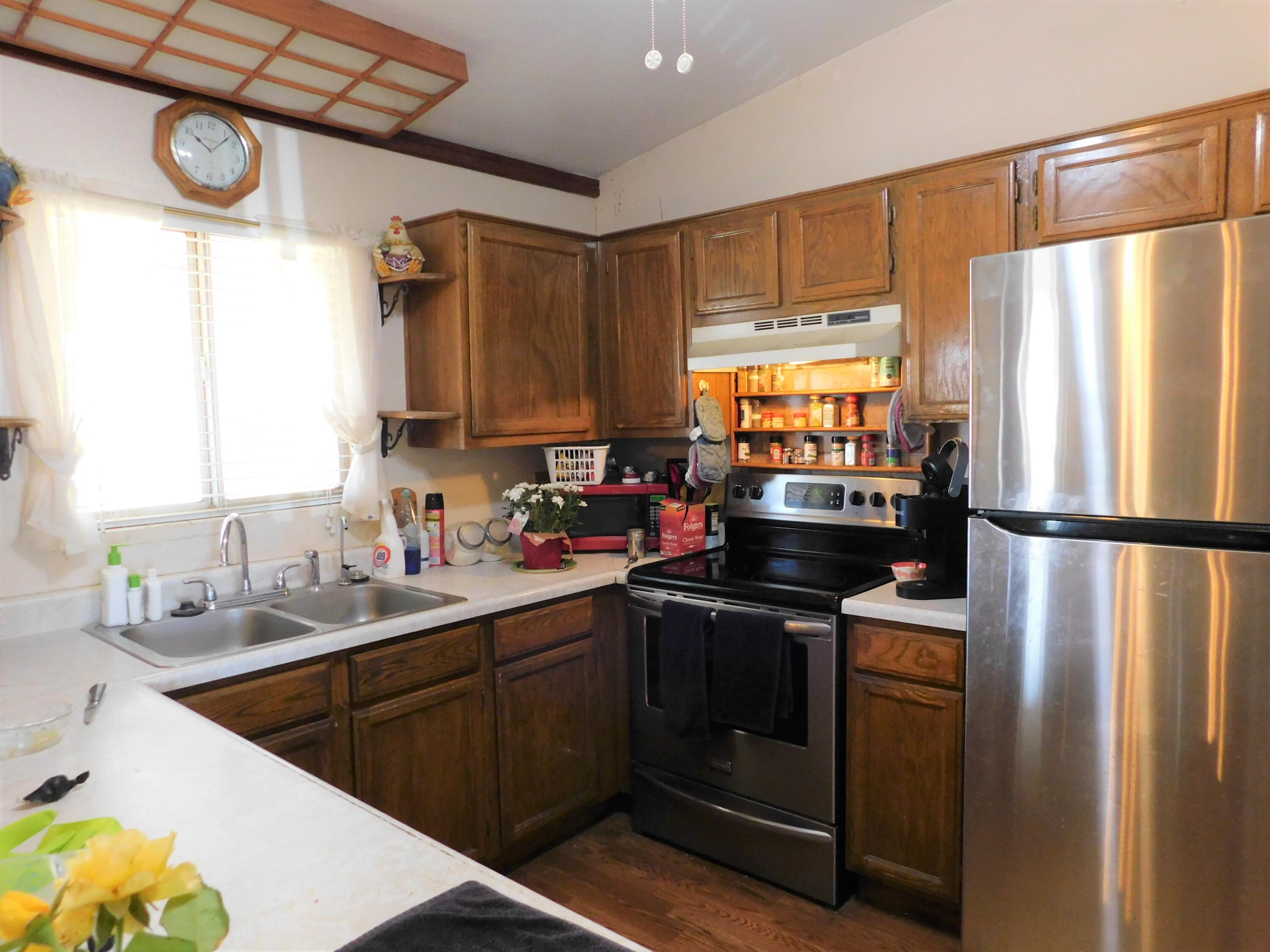 31601 Neuralia Road Mojave, CA 93519 - Photo 5 of 27 a kitchen with stainless steel appliances a refrigerator sink and cabinets