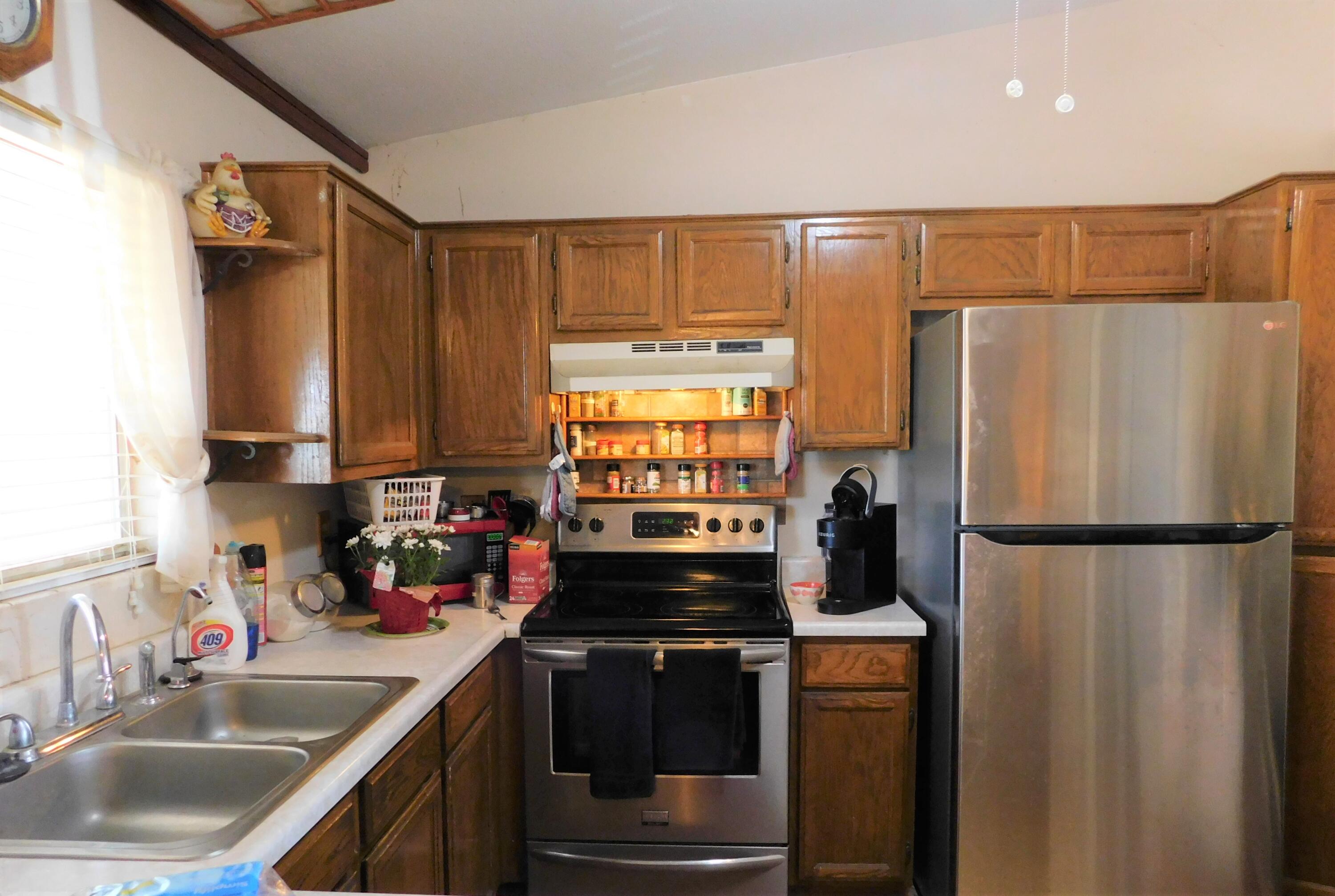 31601 Neuralia Road Mojave, CA 93519 - Photo 6 of 27 a kitchen with a refrigerator and a sink