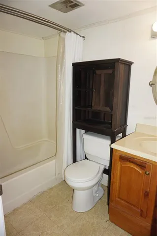a white toilet sitting next to a bathroom sink